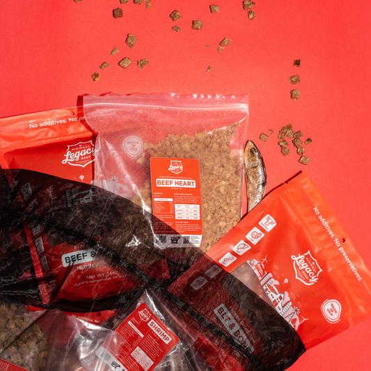 Various packages of beef heart treats on a red background