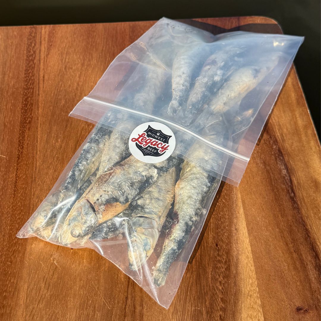 Bag freeze dried sardines on a wooden surface with a visible brand label.
