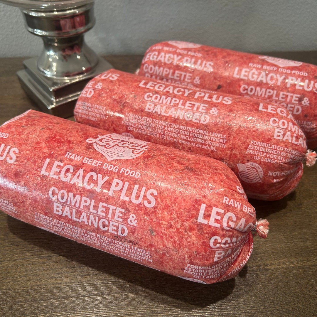 Legacy PLUS Complete & Balanced raw beef dog food log, red, labeled, end cut