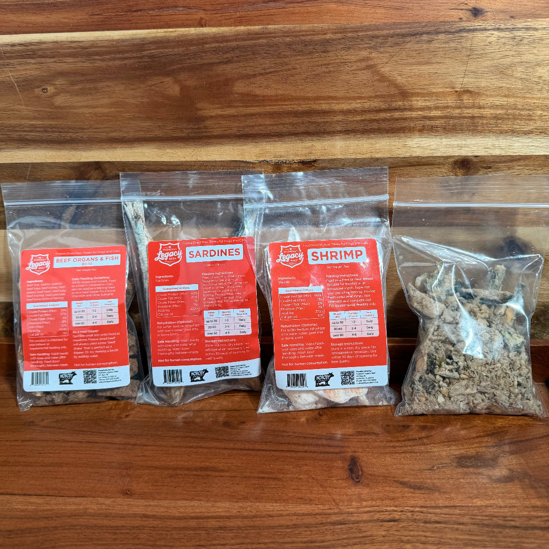 Freeze-dried pet food sample pack with red-labeled pouches and loose pieces.