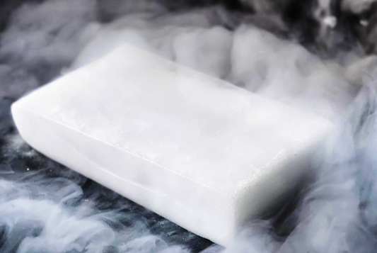 Dry ice block, rectangular white-frosted with visible vapor around edges